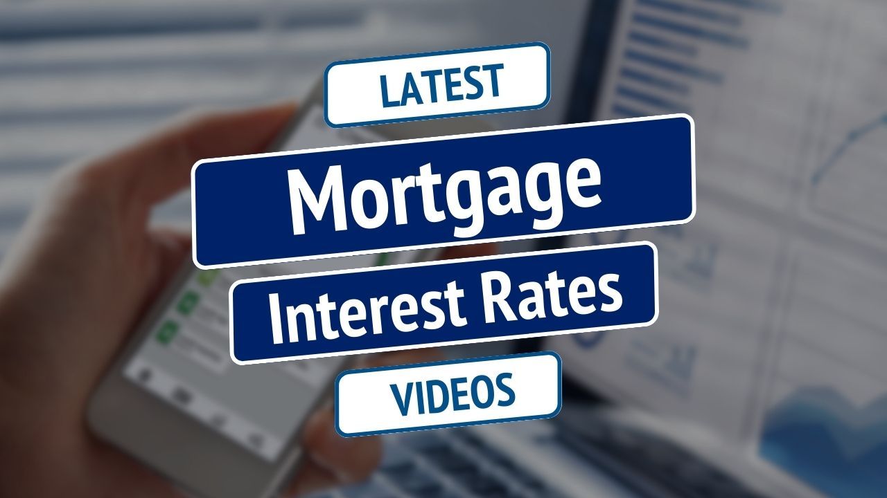 Mortgage interest rates graphic with blue signs labeled “Latest” and “Videos” over a blurred hand holding a phone
