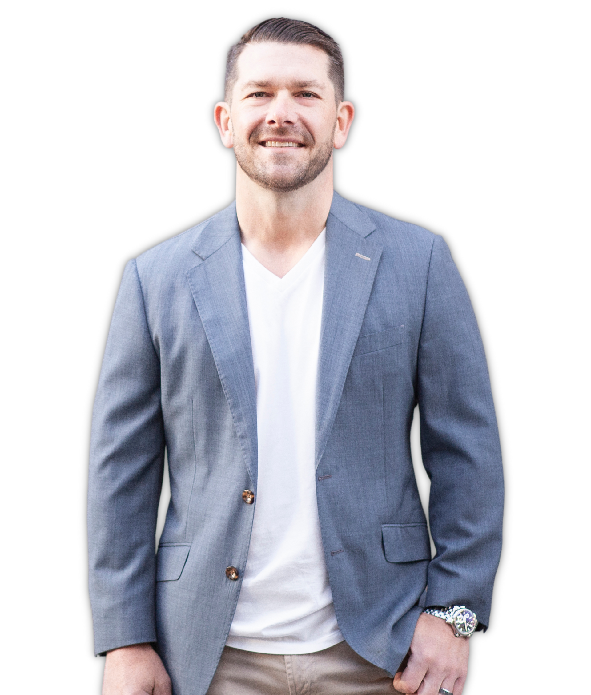 Man in a light blue blazer and white shirt standing against a white background, smiling.