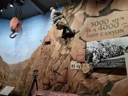 Mobile Detailing-A man is climbing a mountain with a sign that says 5000 men in a 4000 foot canyon