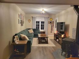 A living room with a couch , coffee table , television and fireplace.