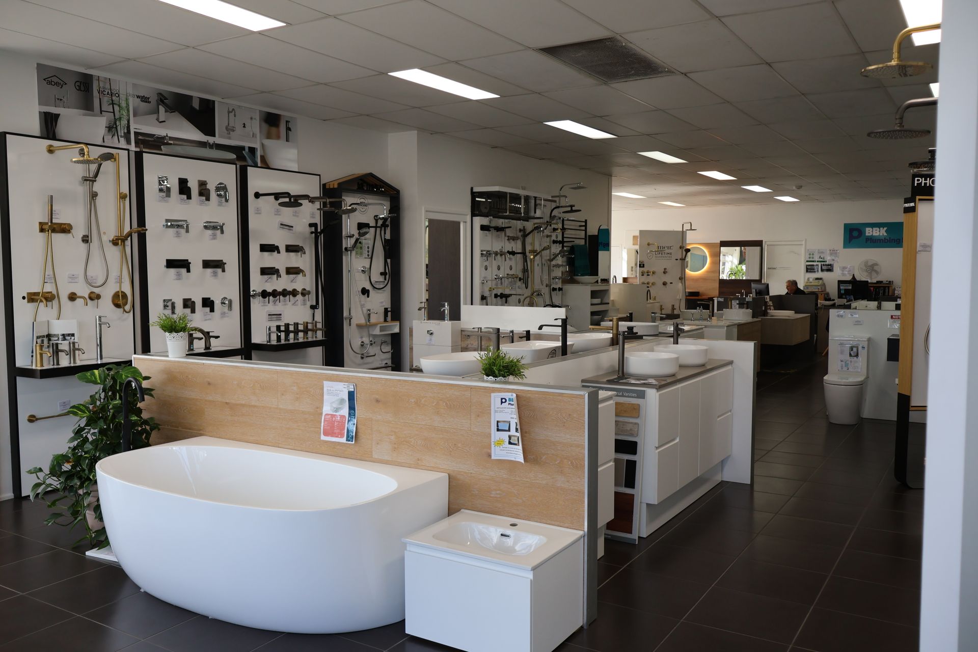 There is a bathtub in the middle of the room in a bathroom showroom.