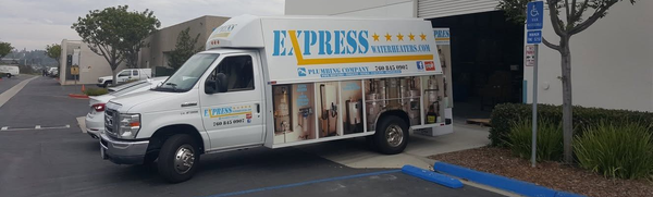 White food truck with colorful “Express” signage parked outside a building on a cloudy day