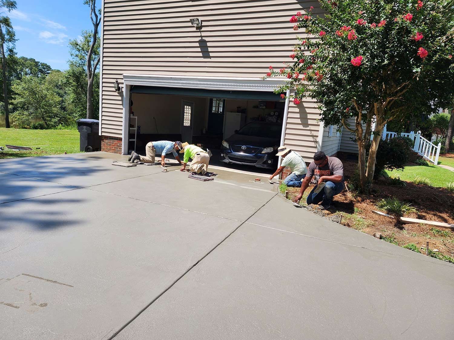 Men Working on a Driveway — Kinston, NC — Hugo's Concrete LLC