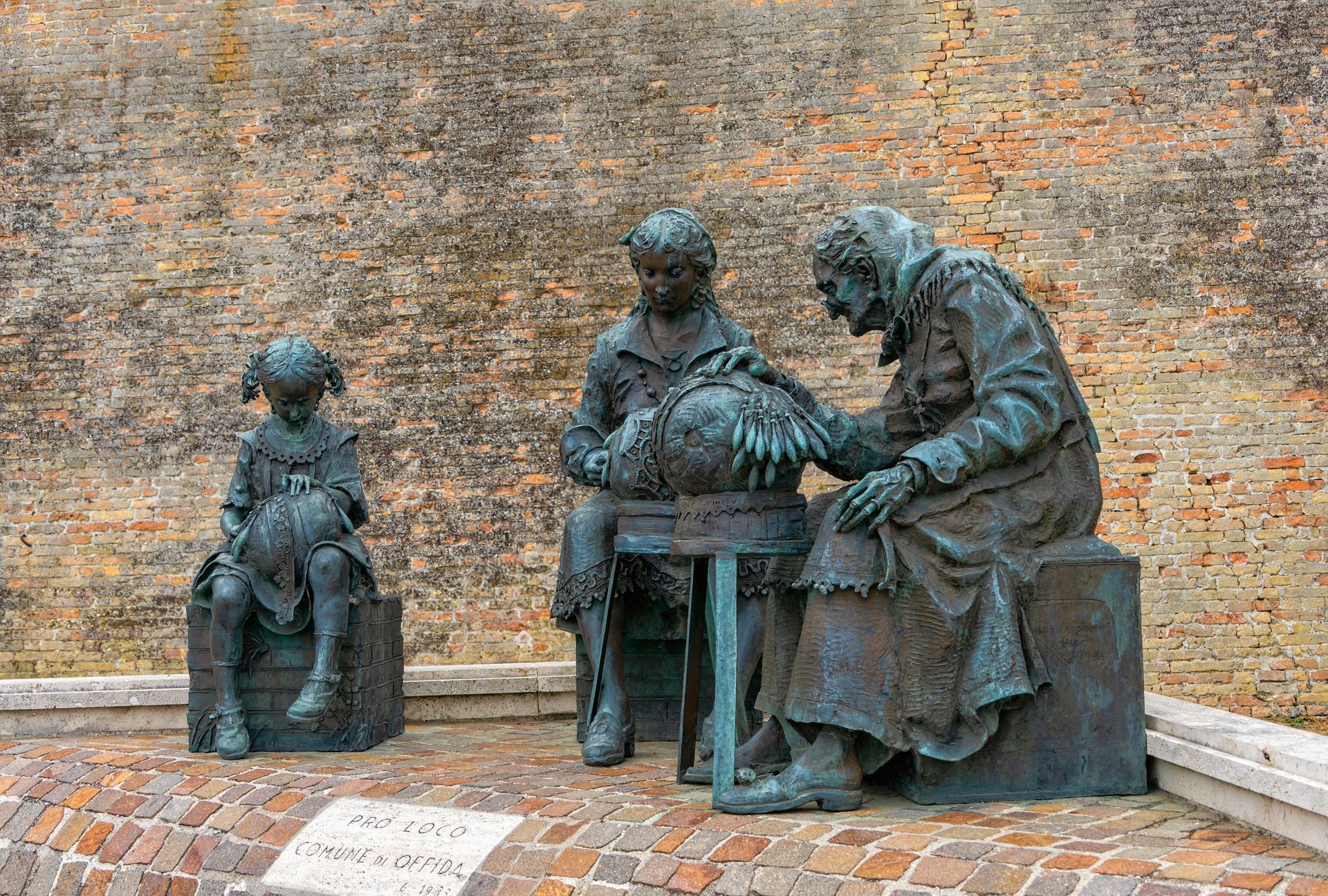 Bronze sculpture depicting three seated figures engaged in a contemplative activity. Bronze sculpture depicting three seated figures engaged in a contemplative activity.