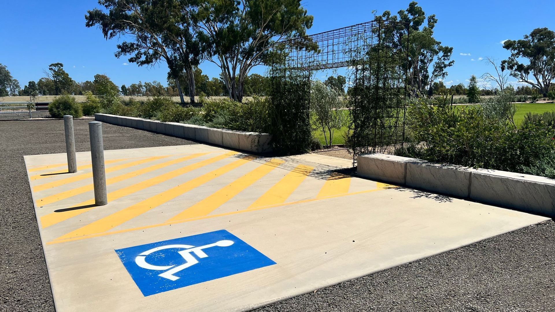 A handicapped parking spot in a parking lot with trees in the background