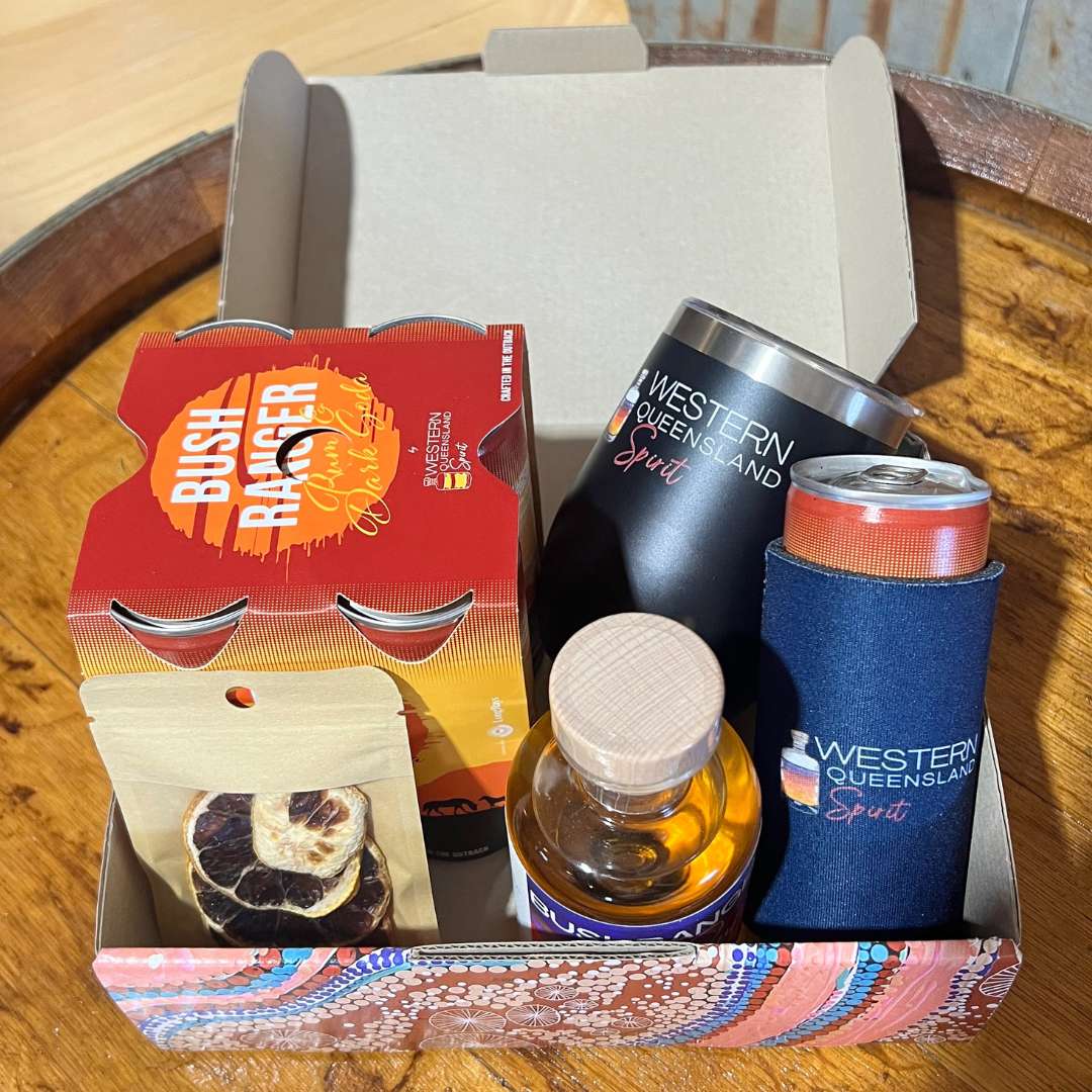 A bottle of bush ranger rum is sitting on top of a wooden table.