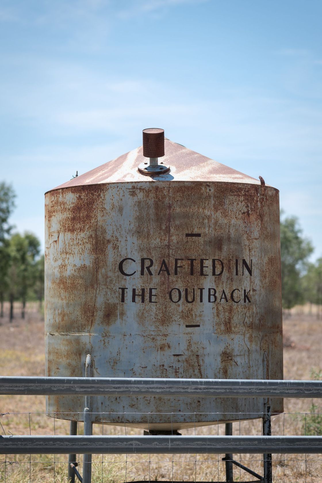 A rusty water tank with the words 