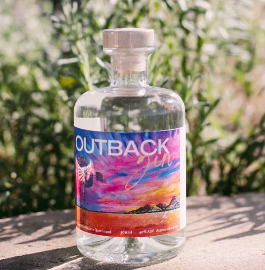 A bottle of outback gin is sitting on a table.