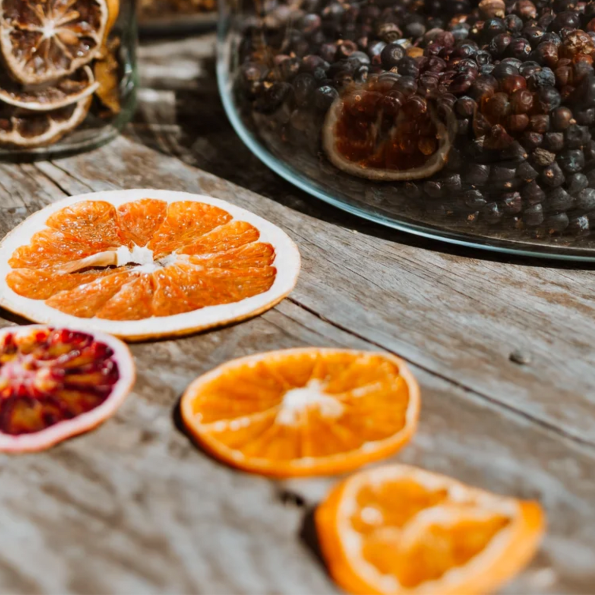 Garnishes including orange and grapefruit laying on a wooden table.