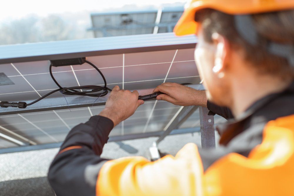 Solar Panel Technician Installing New Solar Panel — Hennig Electrical Services in Nambour, QLD