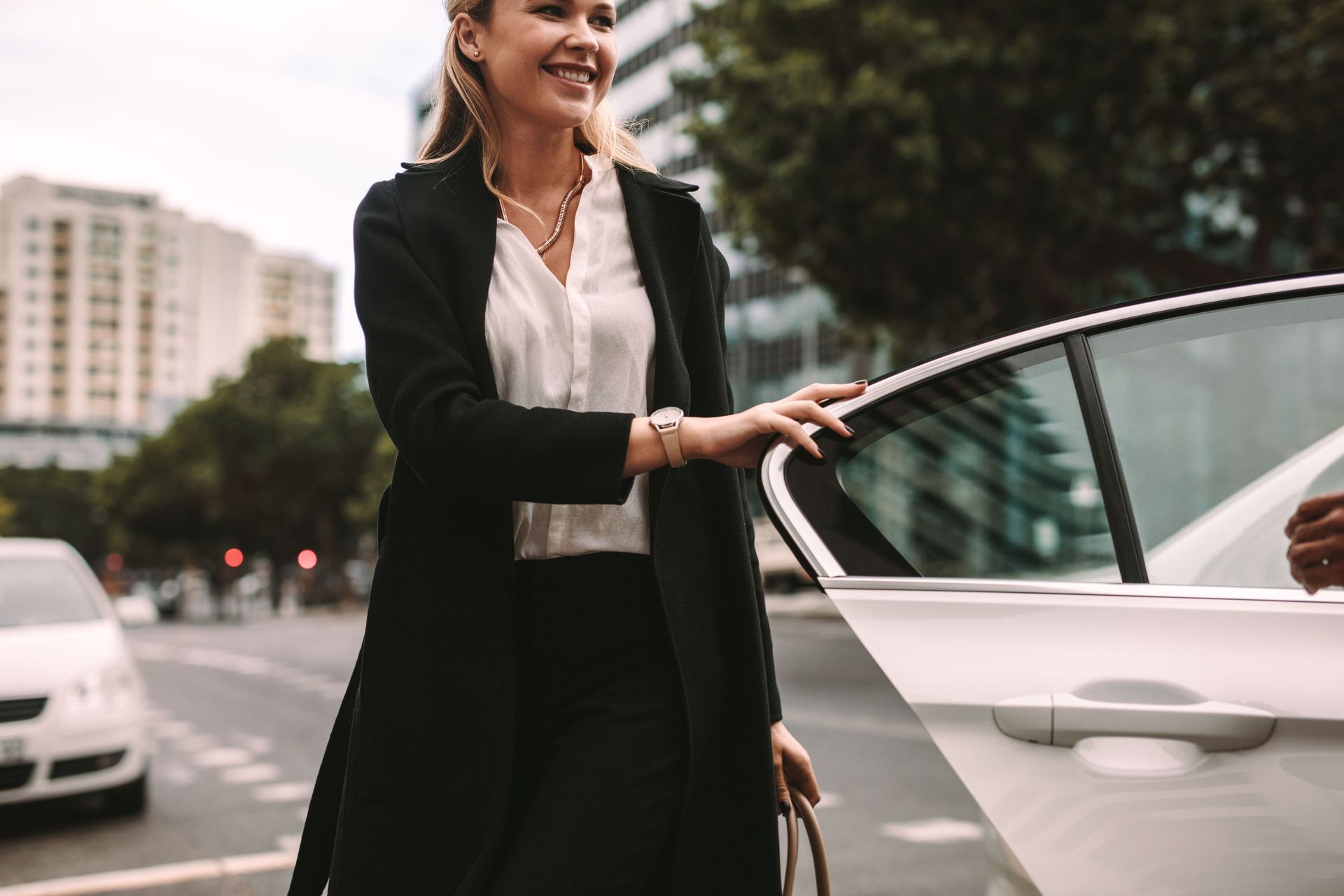 smiling woman commuter getting out taxi