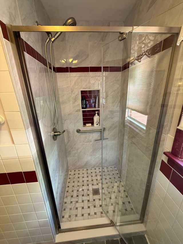 Small bathroom with vanity sink, large mirror, toilet, and shower curtain.