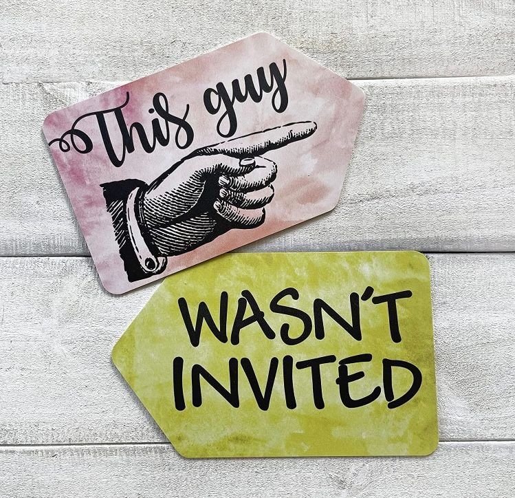 A sign that says this guy wasn't invited on it. Props For Photo Booth