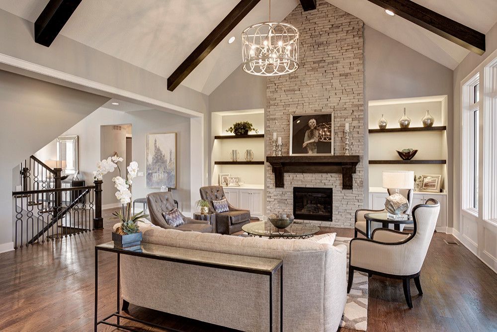 A living room with a couch, chairs, and a fireplace