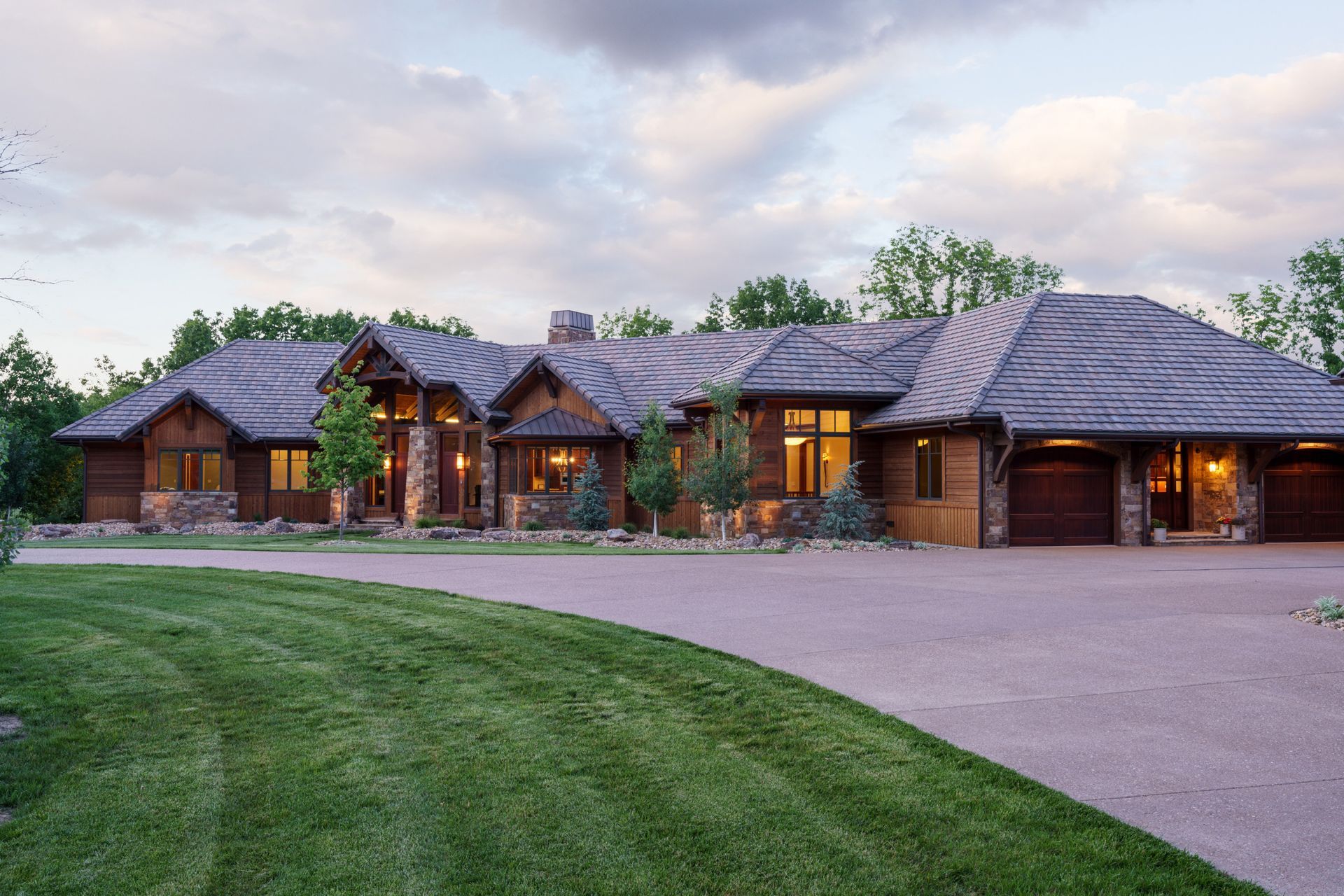 A large house with a lush green lawn in front of it