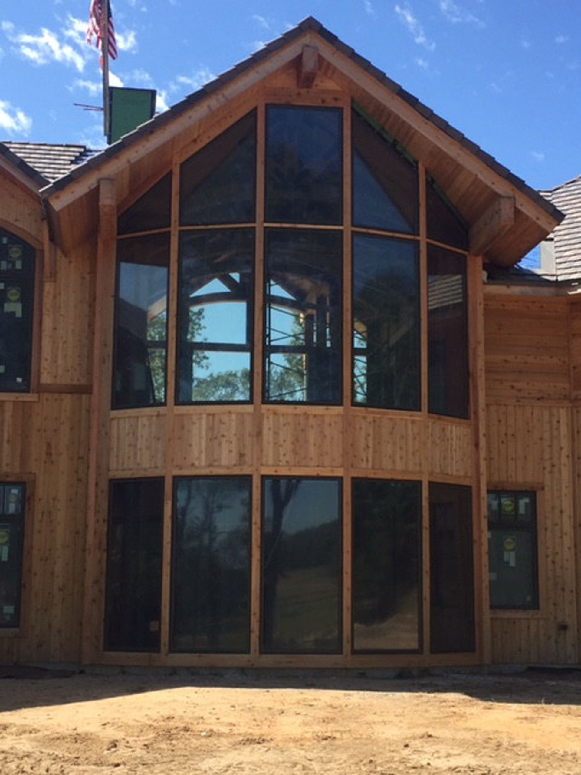 A large wooden house with a lot of windows
