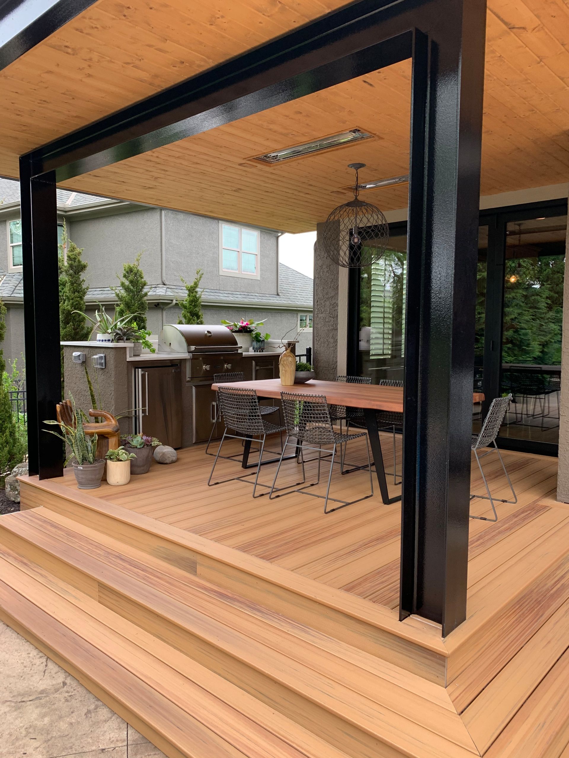 A wooden deck with a table and chairs on it