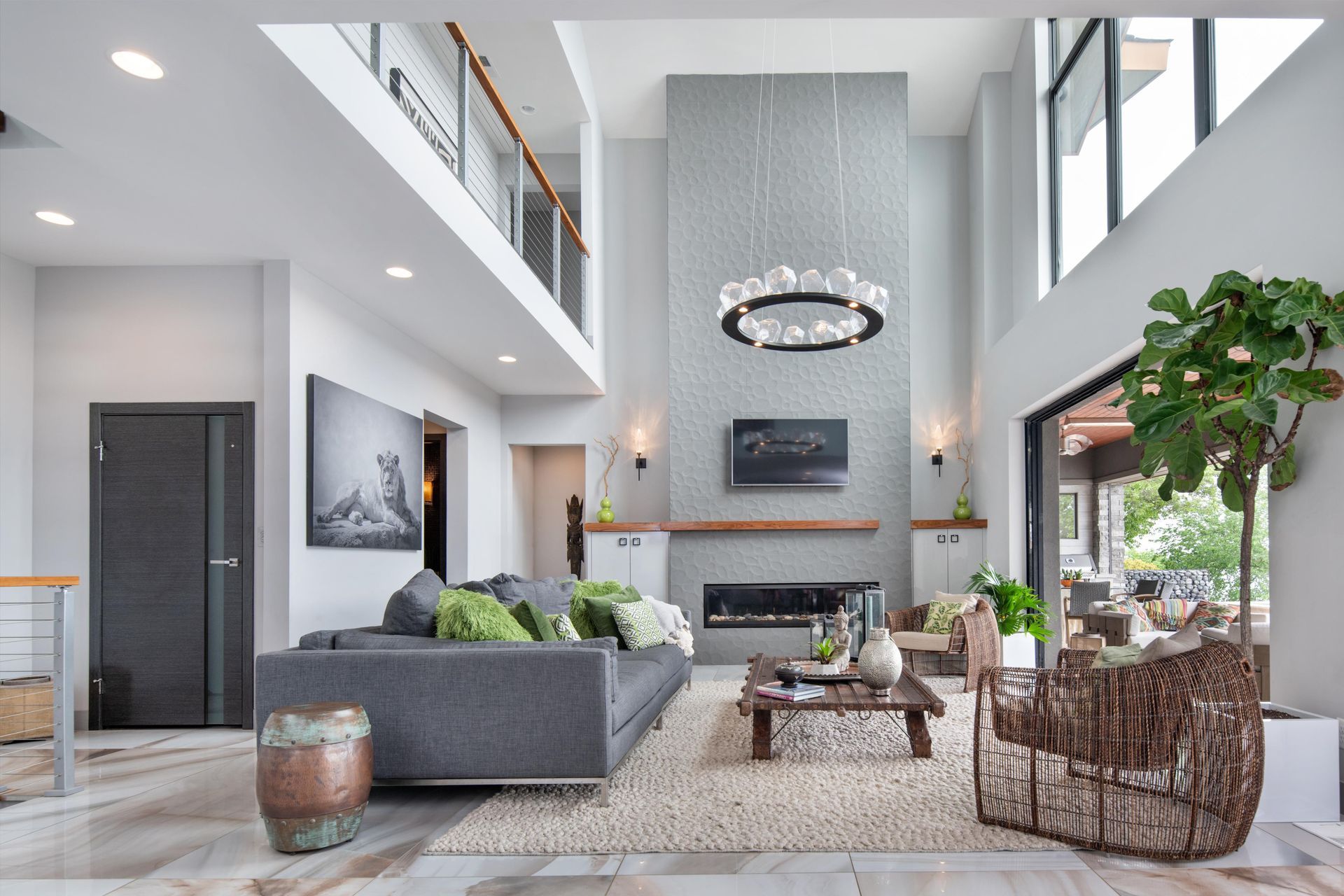 A living room with a couch , chairs , coffee table and fireplace.