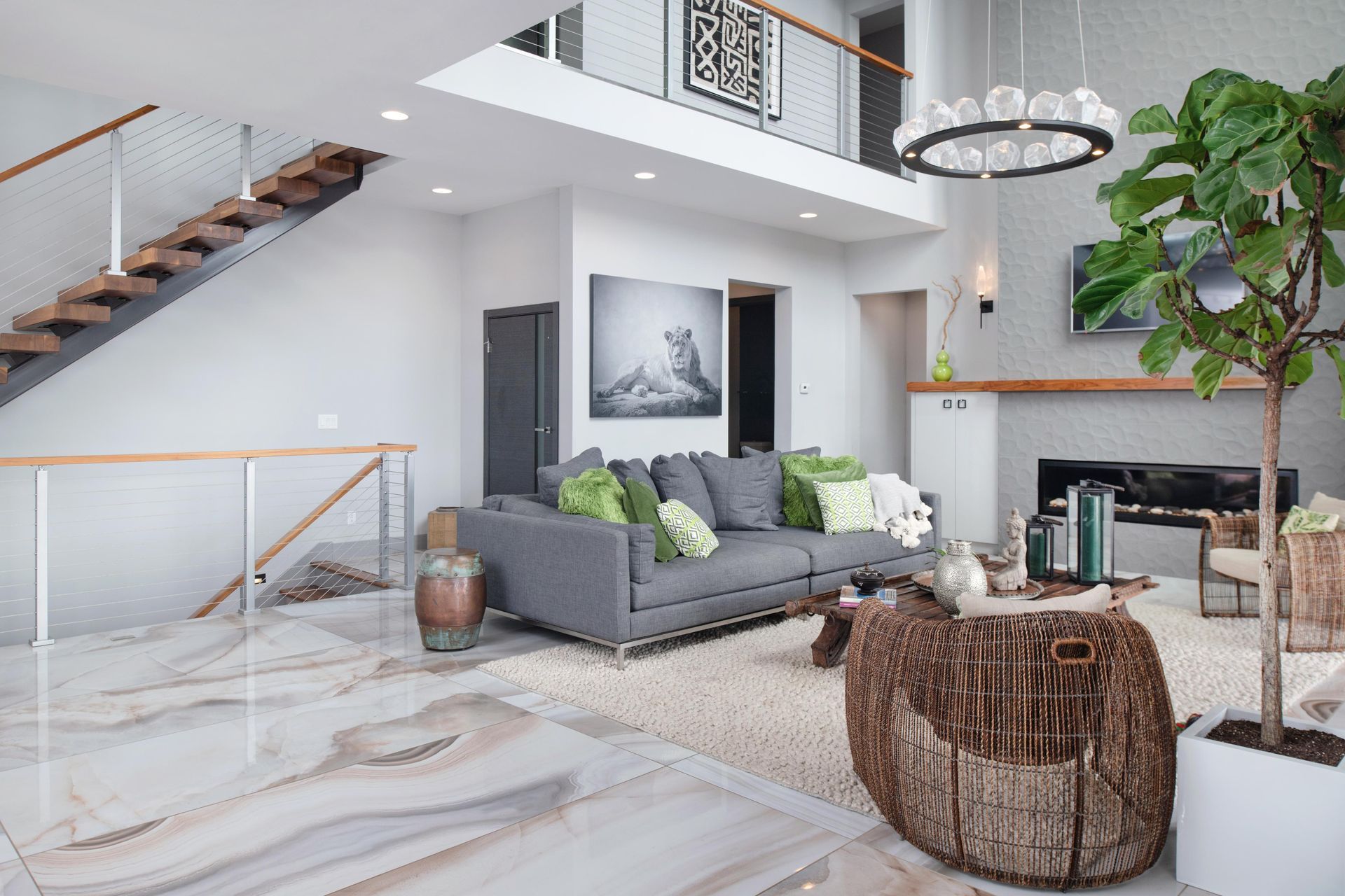 A living room with a couch , coffee table , fireplace and stairs.