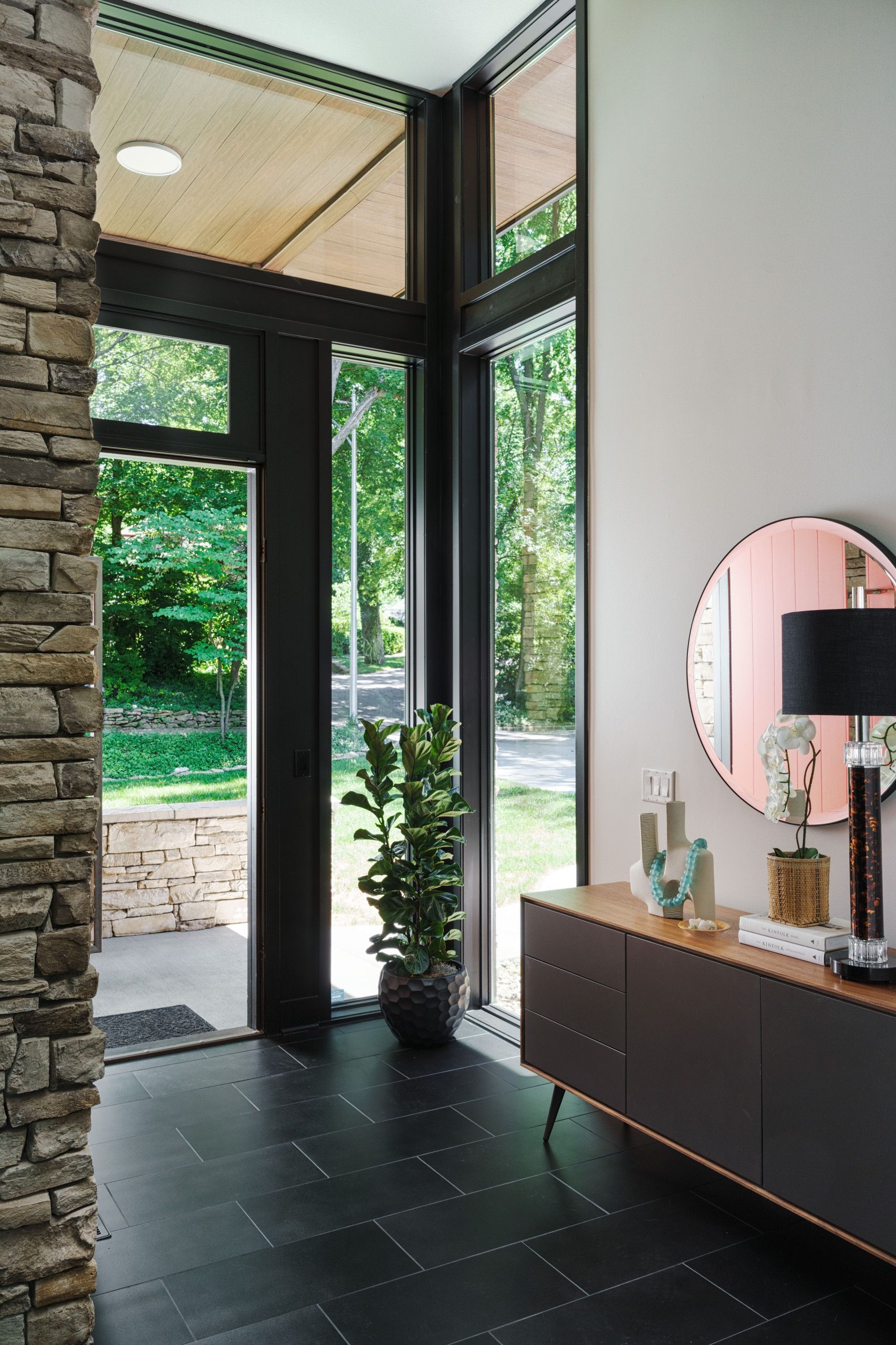 A hallway in a house with a dresser and a mirror