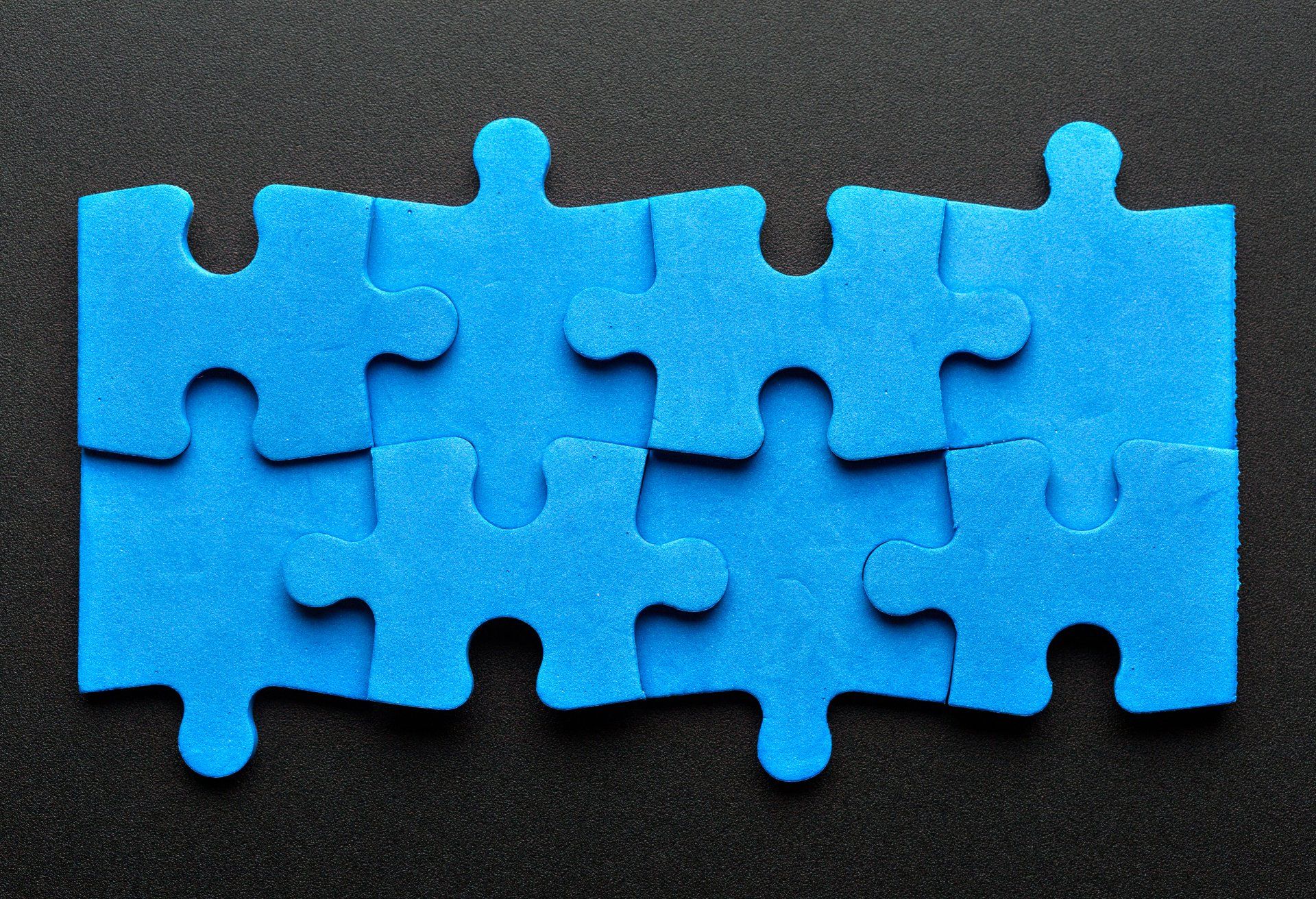 blue puzzle pieces on black background