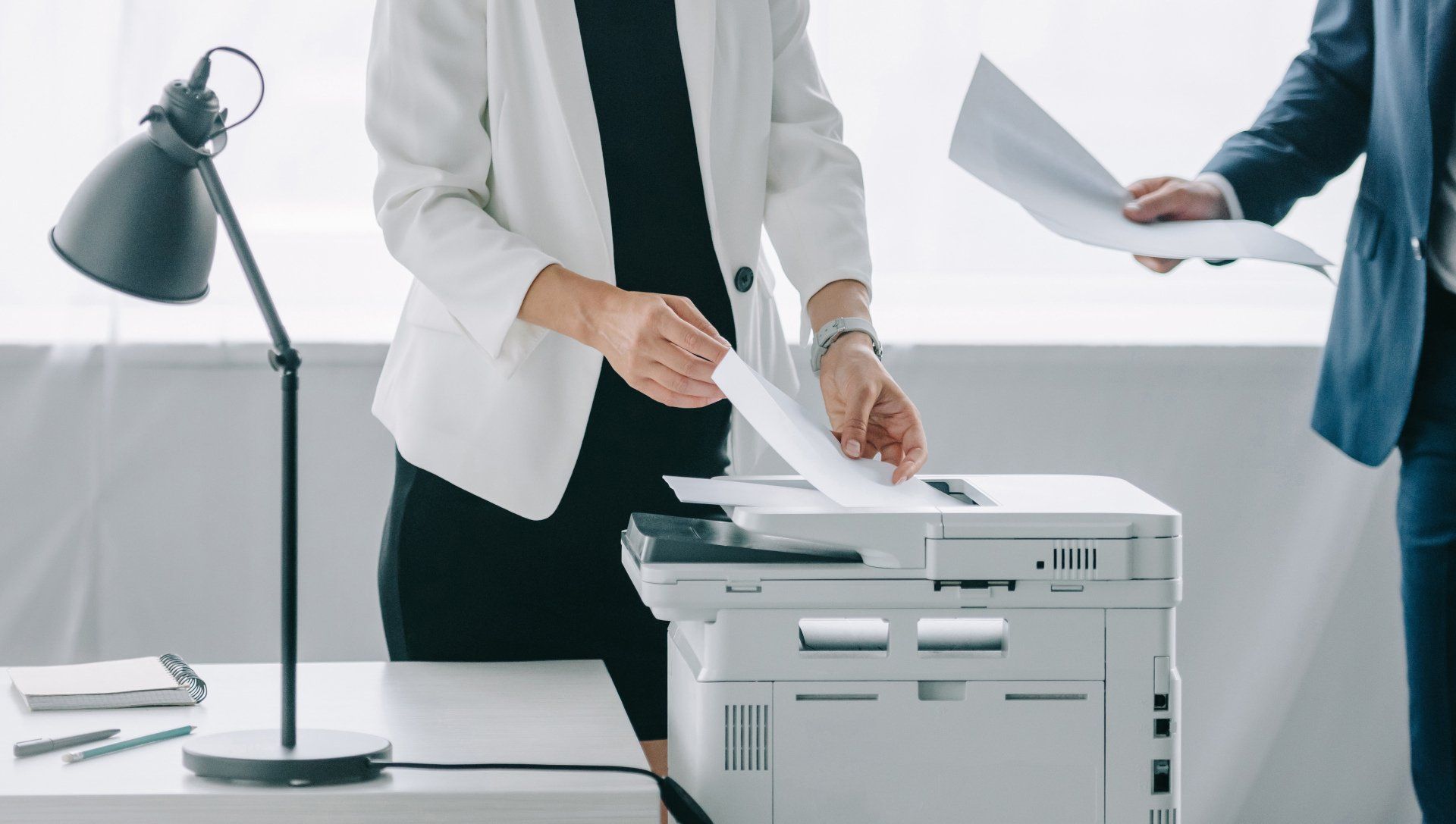 Woman taking paper from printer