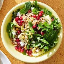 A close up of a salad in a bowl on a table.
