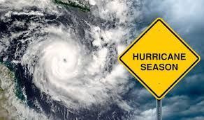 A hurricane season sign with a hurricane in the background.