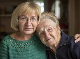 Two older women are posing for a picture together.