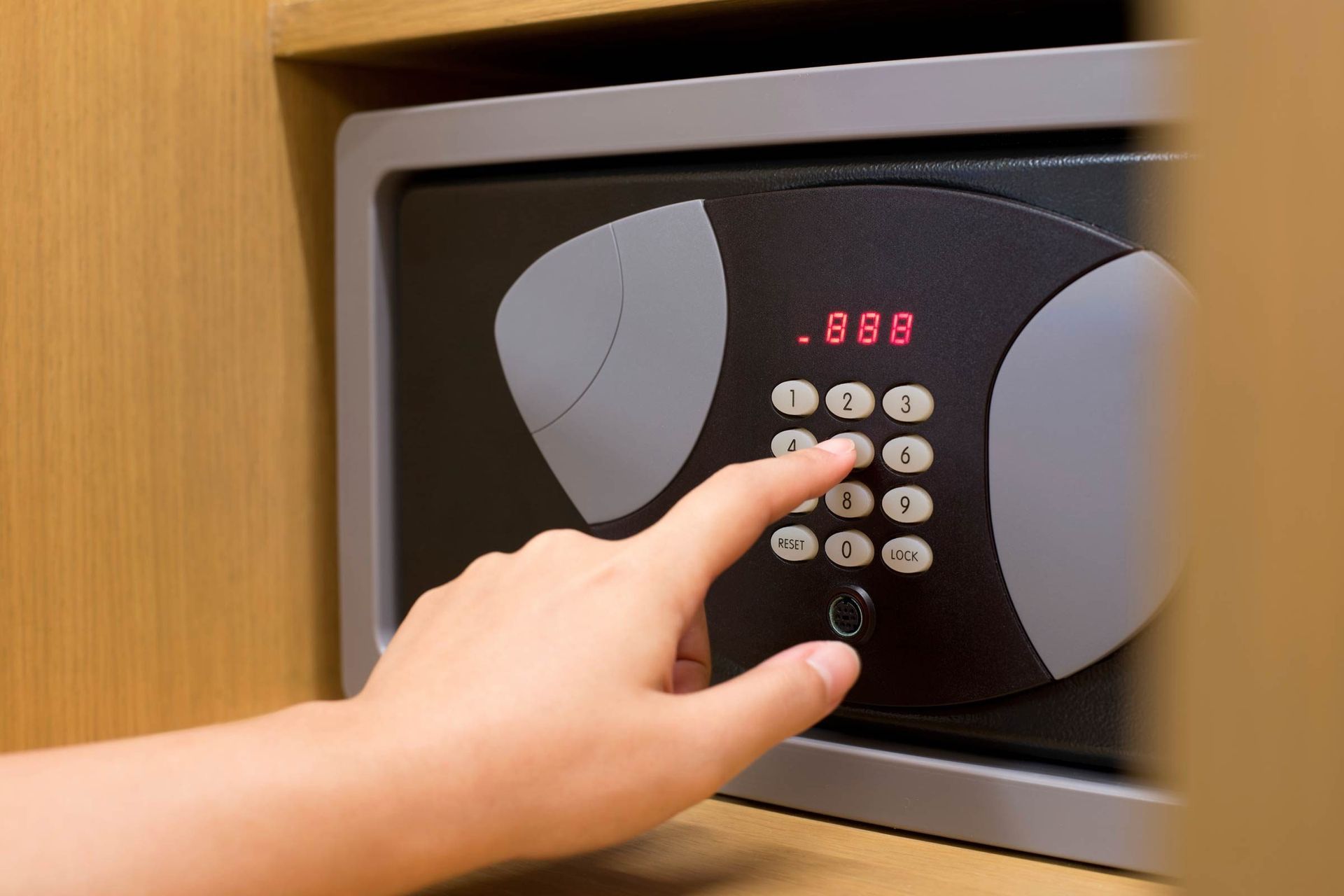 A person is opening a safe with their finger