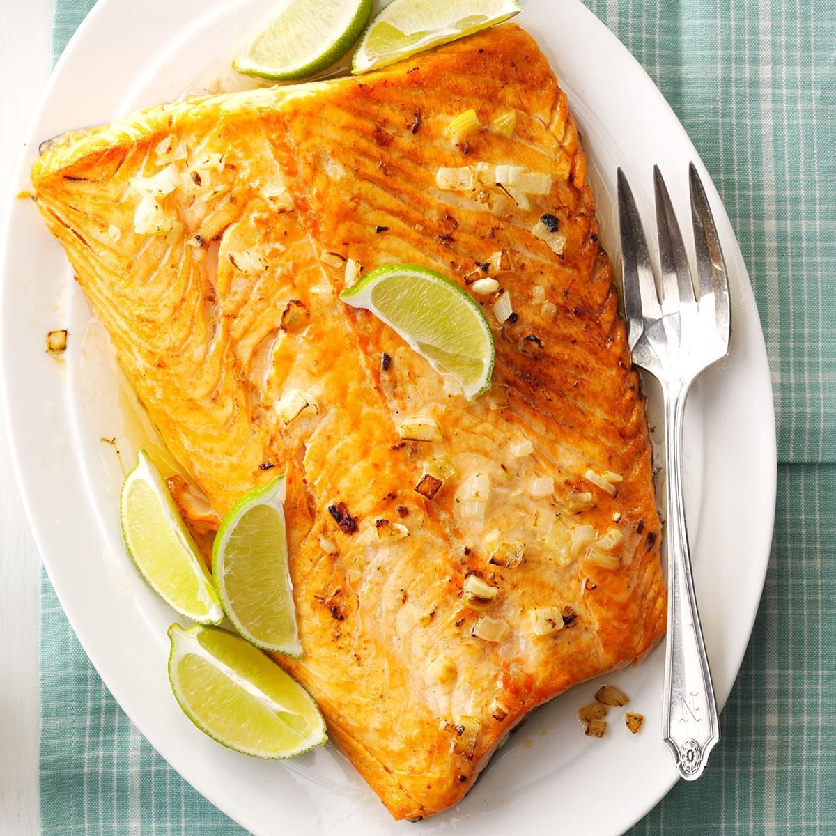 A plate of food with a fork and limes on it