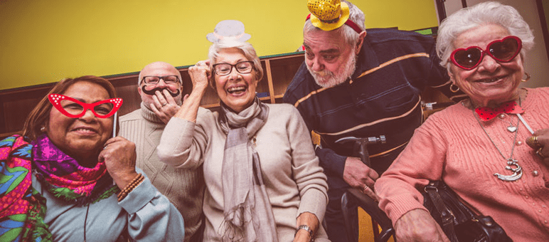 A group of elderly people are posing for a picture.