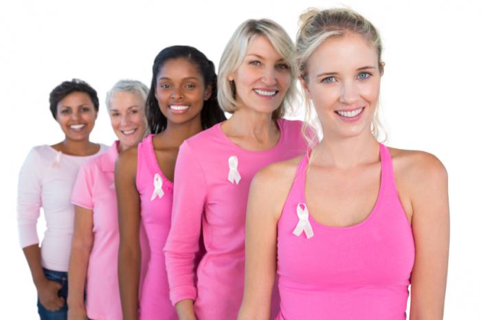 A group of women wearing pink breast cancer awareness shirts