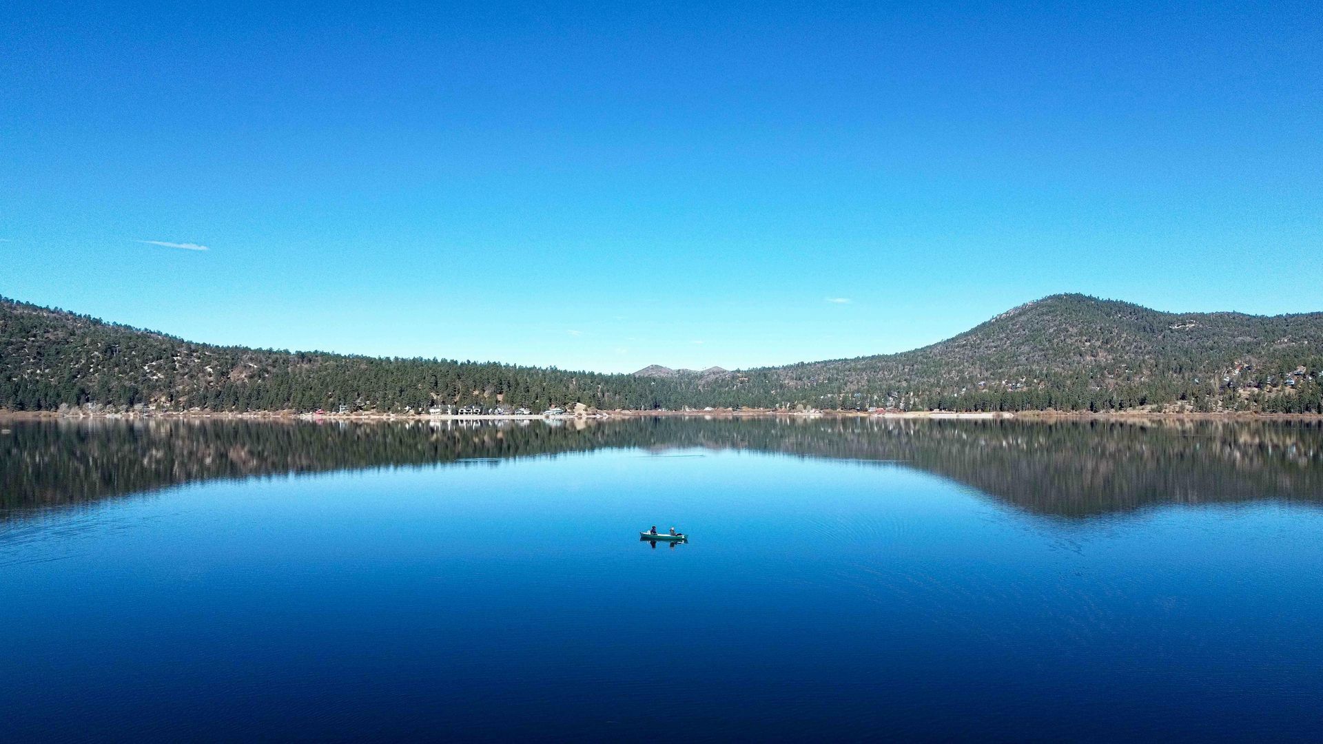 Big Bear Lake reflects mountains and clear blue sky. Big Bear Transportation