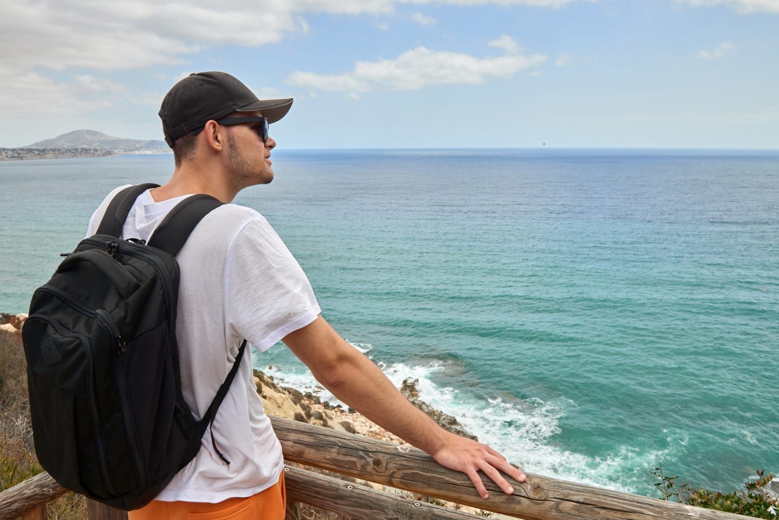man backpacking looking to the coast