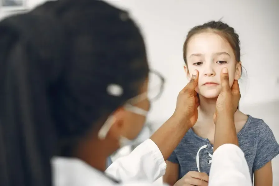 An ENT specialist checks a patient for sinus pressure and facial pain.