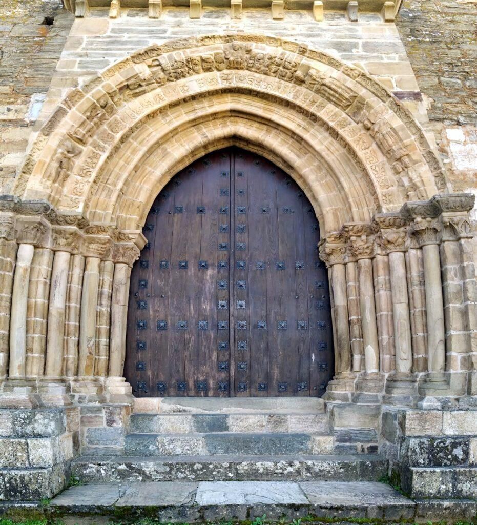 Stone archway with wooden door. Exterior of a building.