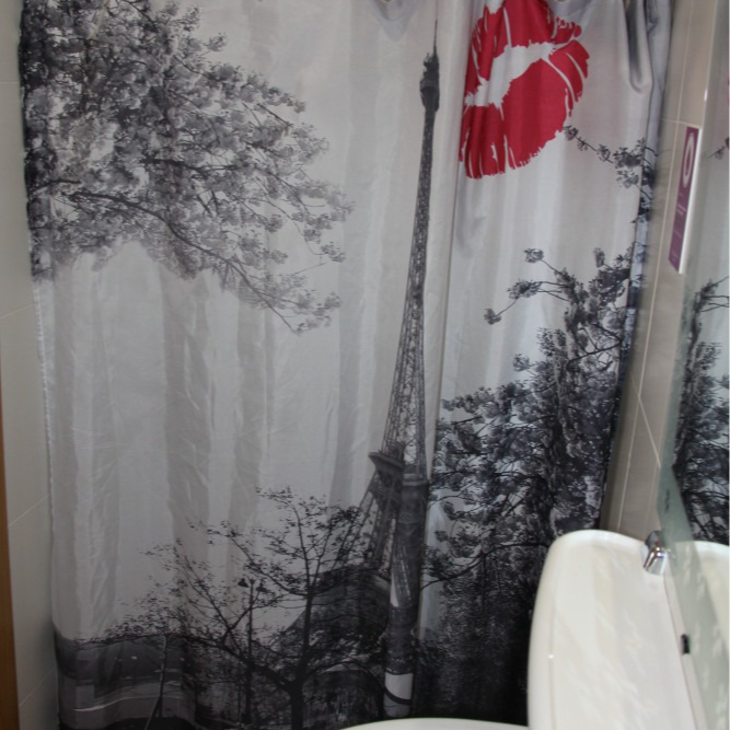 Shower curtain with Eiffel Tower design and red lips.