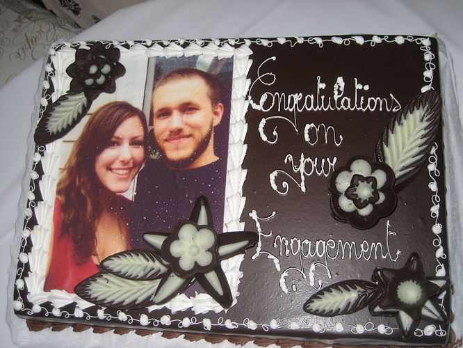 Black wedding scrapbook page with a couple’s photo and “Congratulations on your engagement” in white script