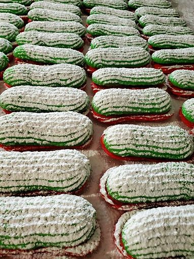 Rows of white, foam-covered watermelons stacked on a market floor