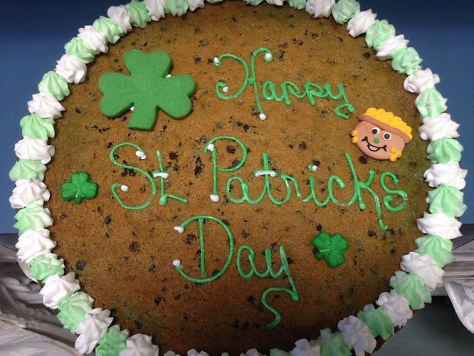 Chocolate cake with green icing reading “Happy St. Patrick’s Day” and shamrock decorations