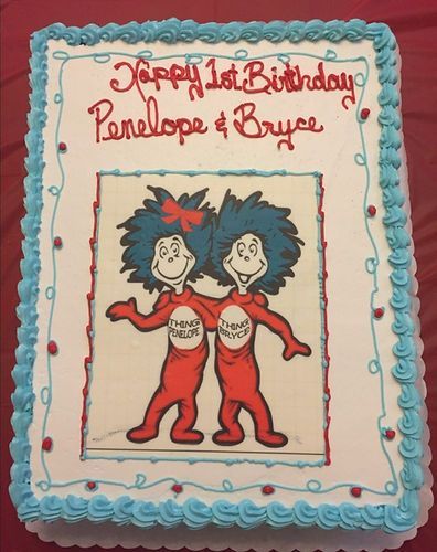 Happy birthday cake with blue frosting border and cartoon characters in red outfits