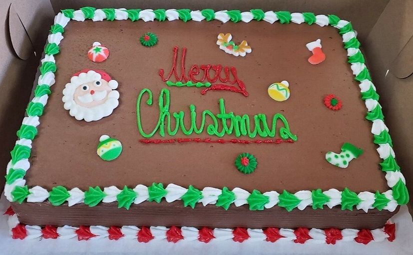 Chocolate Christmas cake with green and red icing, Santa decoration, and festive border frosting