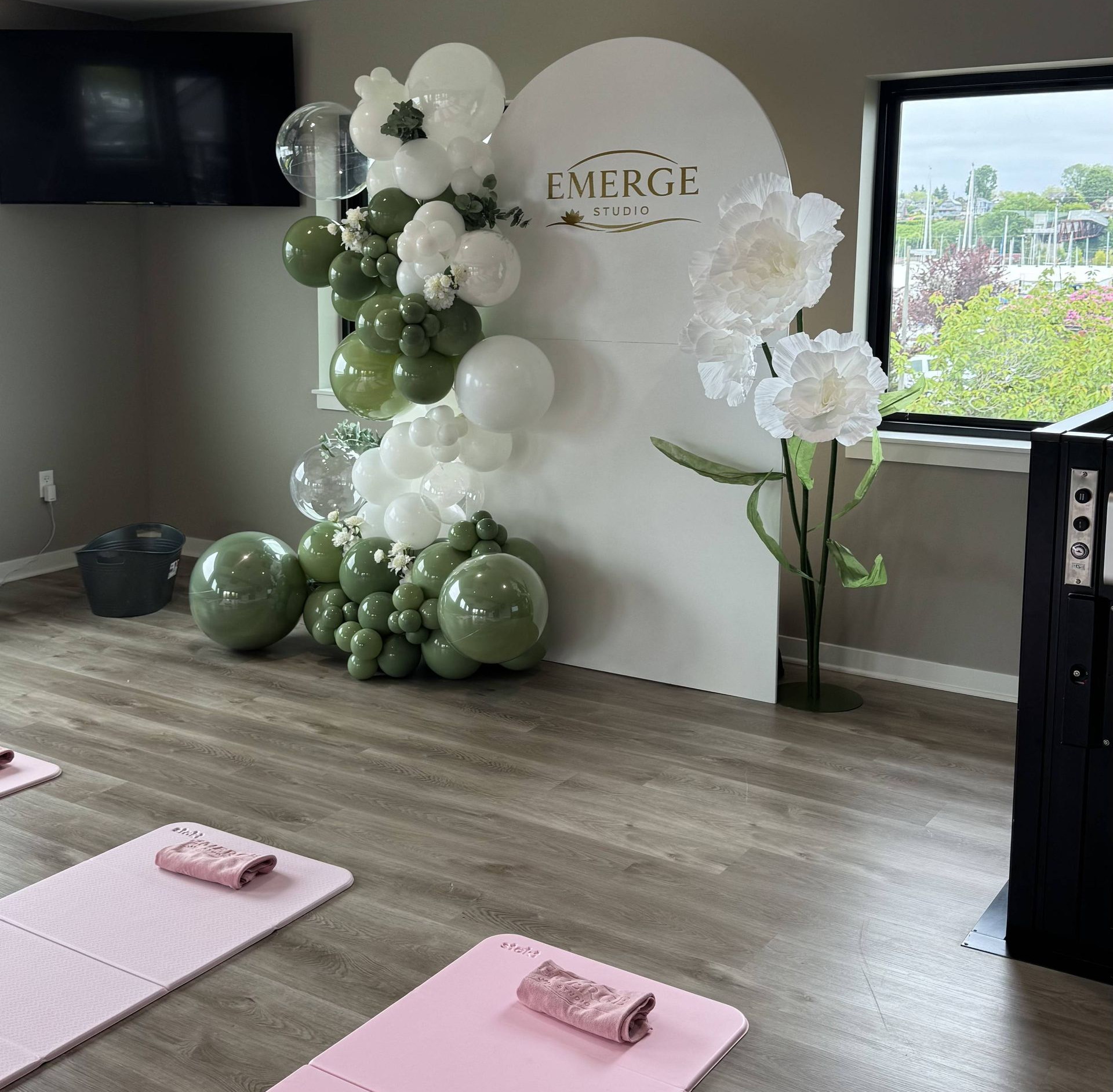 yoga studio with green and white balloon celebration