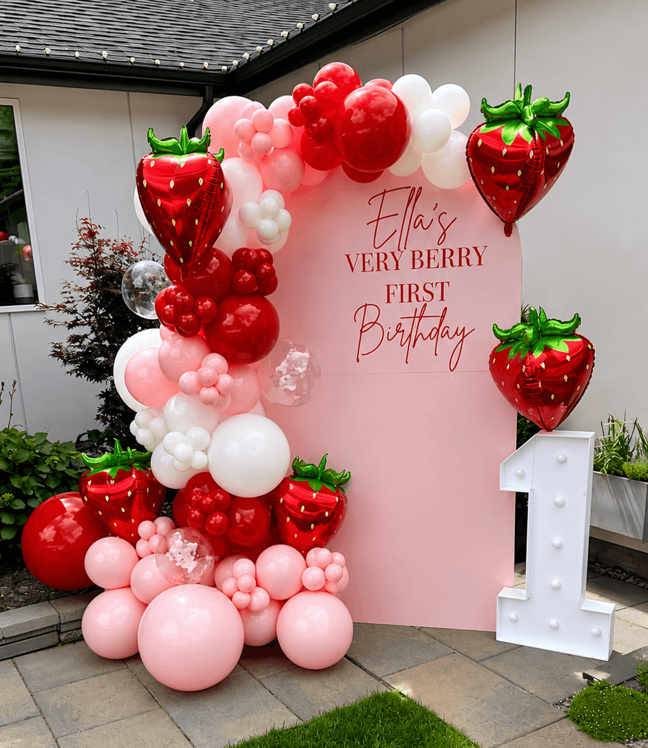 Baby birthday party with strawberry balloons