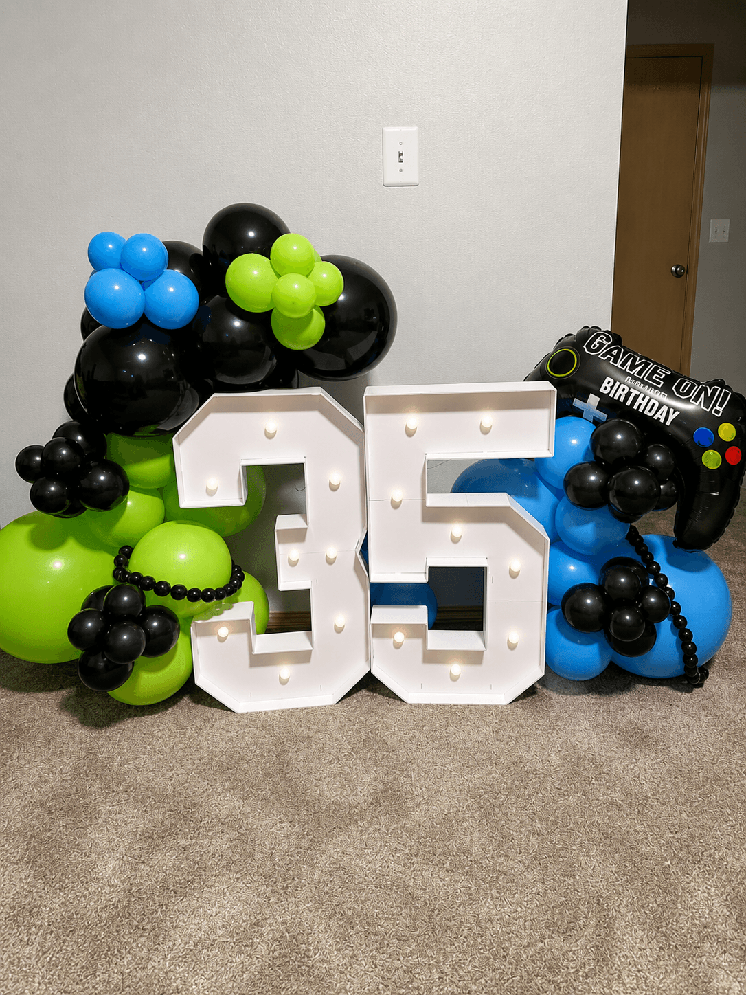 video game themed party with black and green balloons