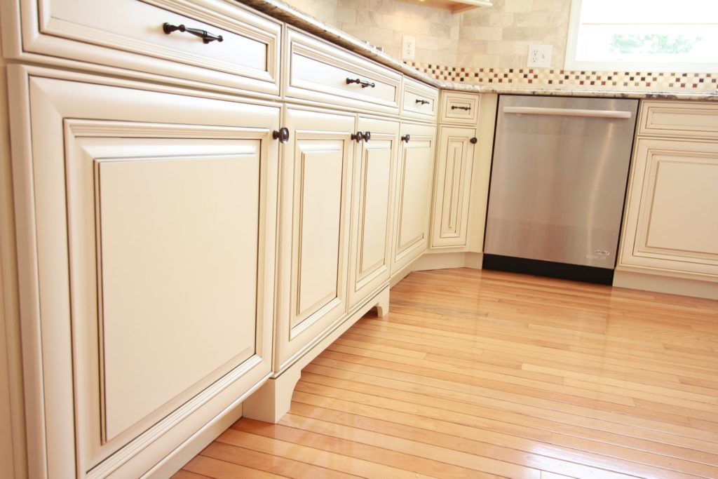 A kitchen with white cabinets and a stainless steel dishwasher.