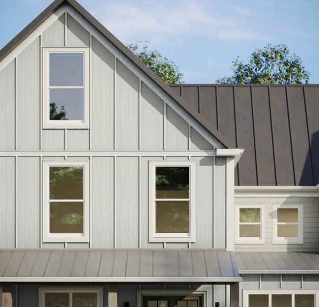 Close-up of a two-story house with gray siding, white trim, and a dark metal roof.