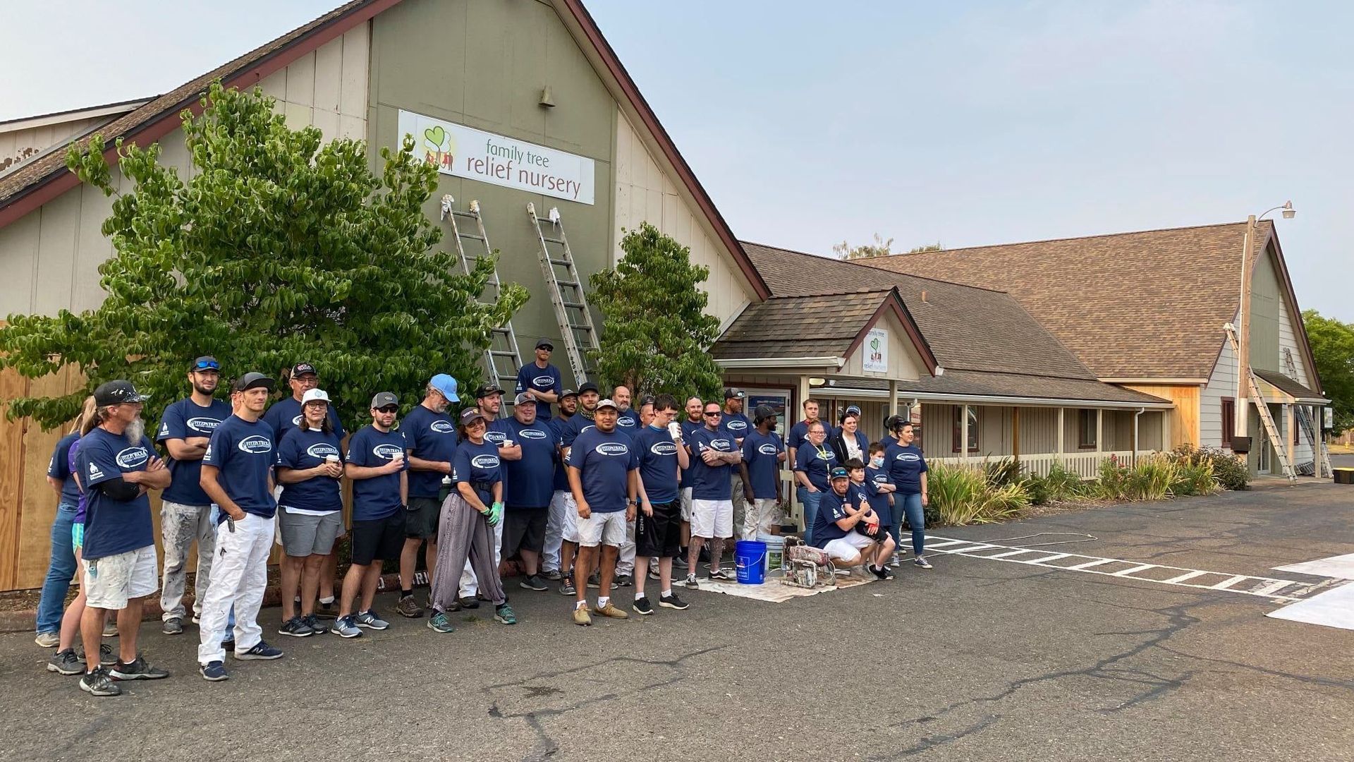 A group of people are standing in front of a building.