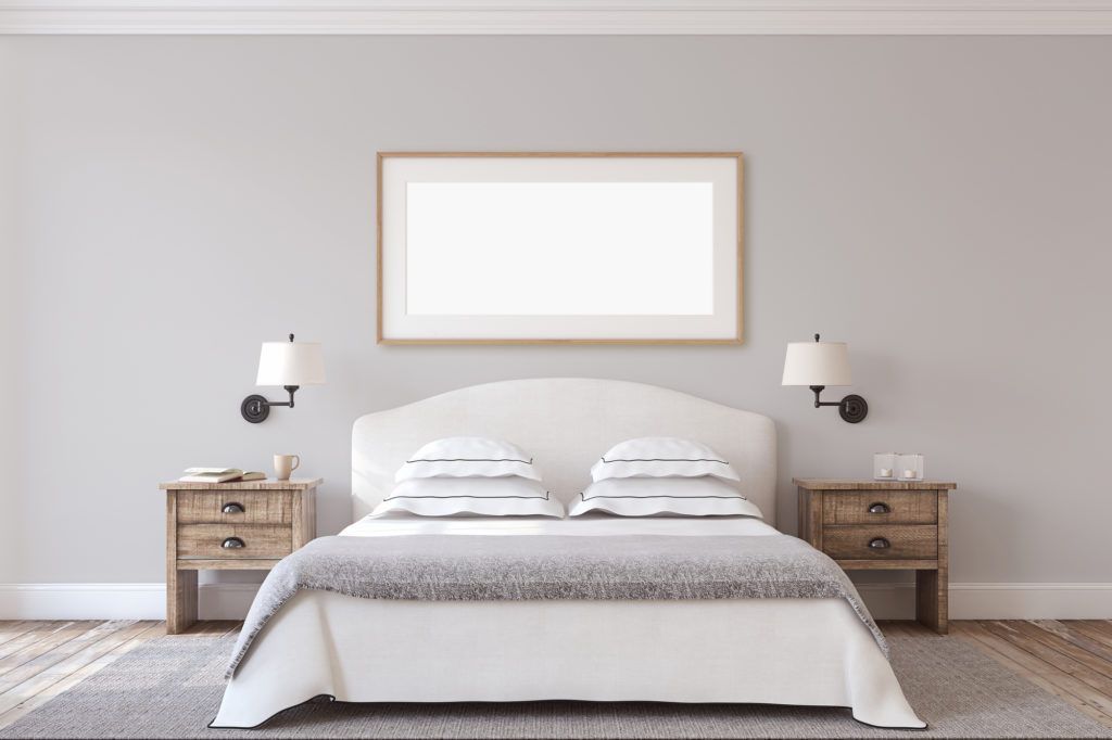There is a picture frame above the bed in the bedroom.